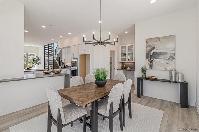 dining area featuring an inviting chandelier and light wood-type flooring