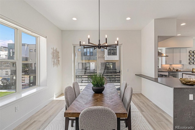 dining room featuring an inviting chandelier and light wood-type flooring