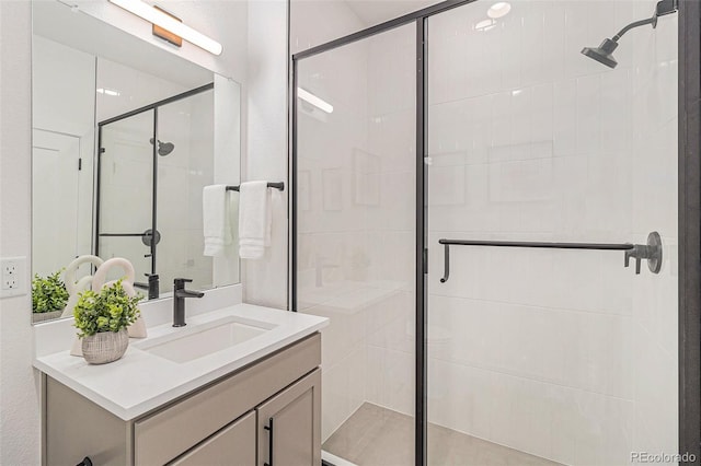 bathroom with vanity and a shower with shower door