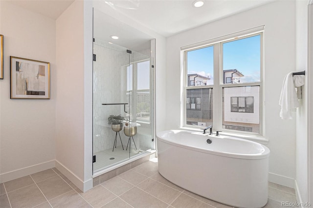 bathroom with separate shower and tub and tile patterned floors