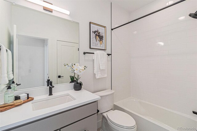 full bathroom featuring vanity, toilet, and tiled shower / bath