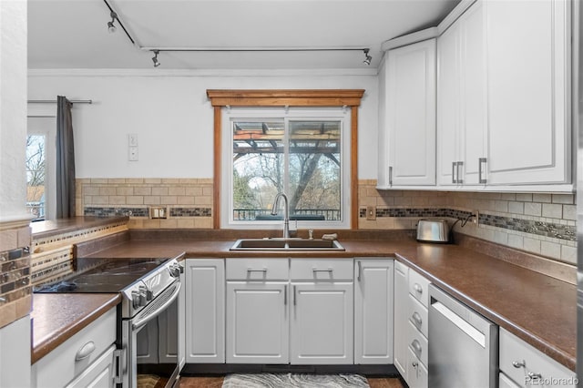 kitchen with stainless steel appliances, white cabinetry, and sink