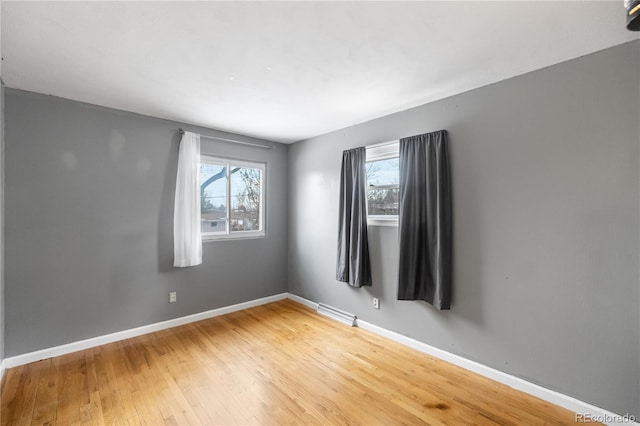 unfurnished room with wood-type flooring