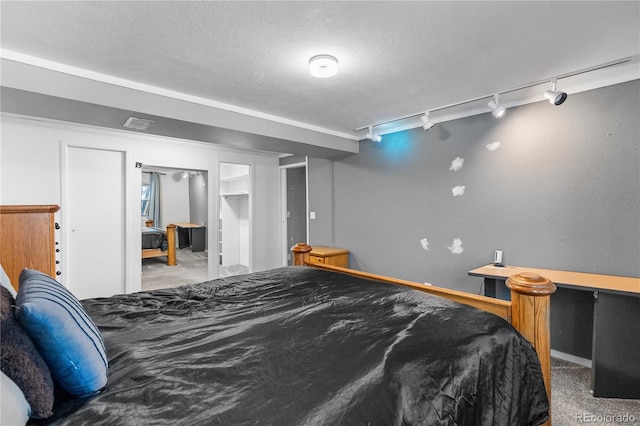 carpeted bedroom with a textured ceiling