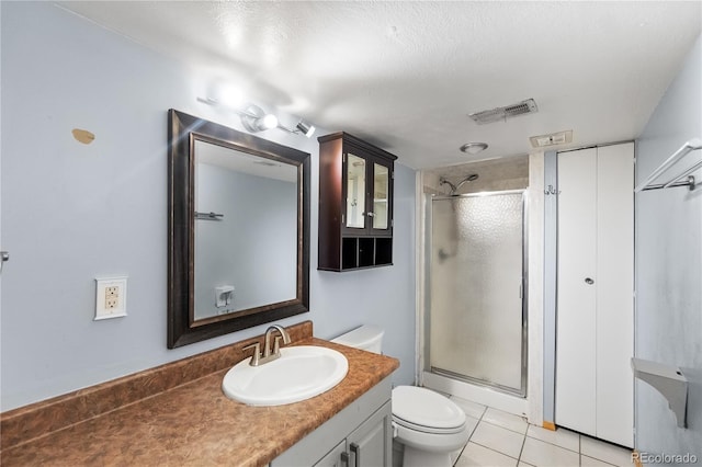 bathroom featuring vanity, toilet, tile patterned flooring, and a shower with door