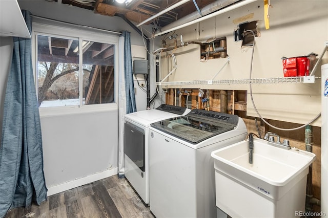 laundry area featuring sink, dark hardwood / wood-style floors, and independent washer and dryer