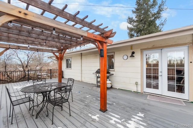 wooden deck with a pergola, grilling area, and french doors