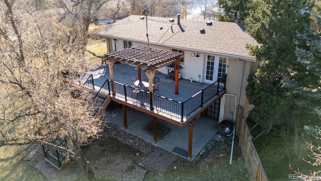 rear view of house featuring a wooden deck and a pergola