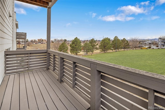 wooden terrace featuring a yard