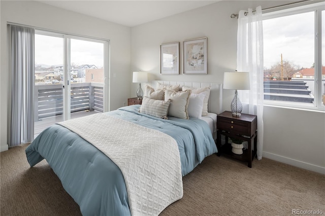 carpeted bedroom with access to outside and baseboards