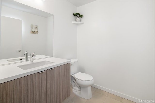 half bath featuring baseboards, vanity, toilet, and tile patterned floors