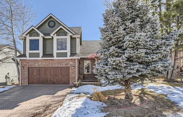 view of front of home with a garage, decorative driveway, and brick siding