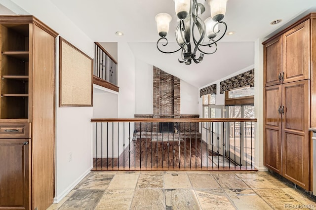 kitchen featuring open shelves, stone tile floors, recessed lighting, lofted ceiling, and a chandelier