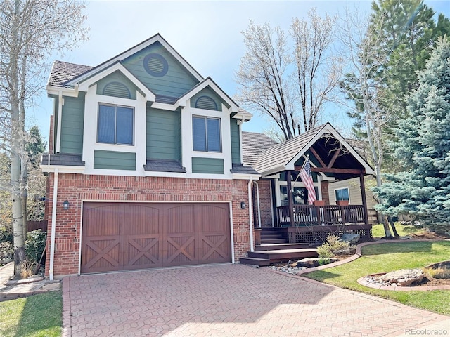 27 Buckthorn Dr, Littleton, CO 80127 - view of front of house featuring a garage, brick siding, and decorative driveway