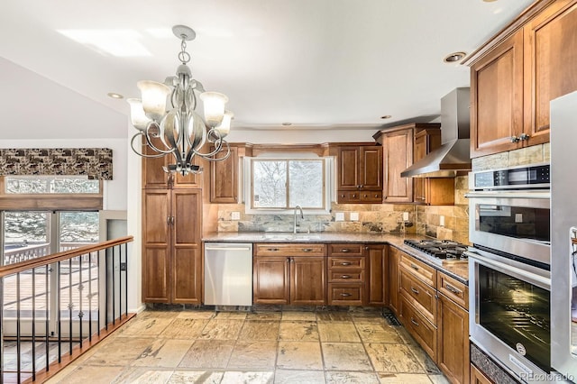 27 Buckthorn Dr, Littleton, CO 80127 - kitchen with an inviting chandelier, wall chimney range hood, appliances with stainless steel finishes, stone tile floors, and a sink