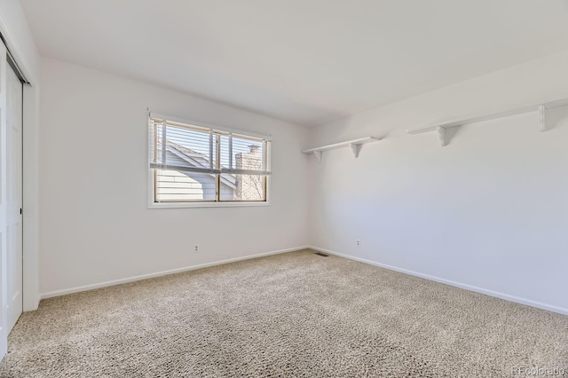 27 Buckthorn Dr, Littleton, CO 80127 - spare room featuring visible vents, baseboards, and carpet