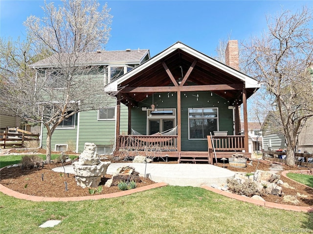 27 Buckthorn Dr, Littleton, CO 80127 - back of house featuring a yard, fence, and a chimney