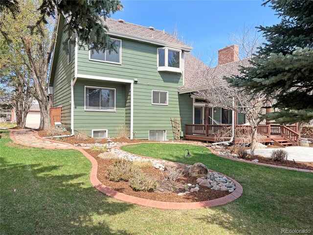 27 Buckthorn Dr, Littleton, CO 80127 - rear view of house with a deck, a chimney, and a lawn