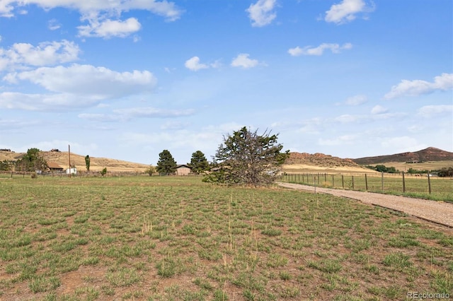 view of yard with a mountain view and a rural view