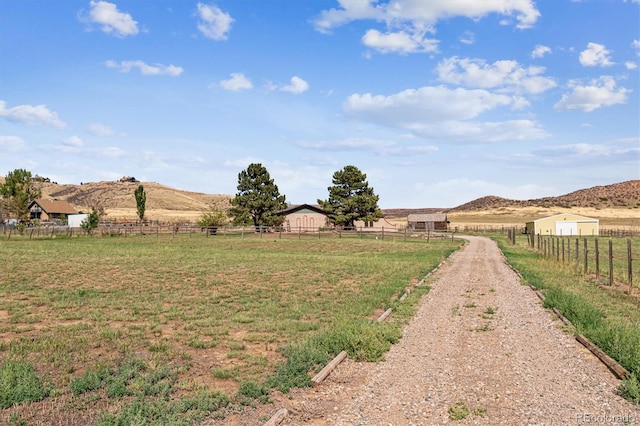 view of yard with a mountain view and a rural view