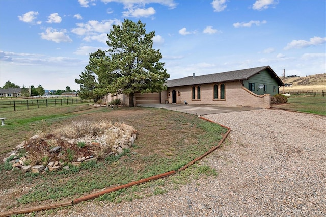 view of front of property featuring a rural view and a patio area