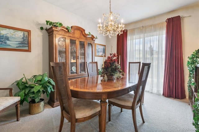 dining room featuring light colored carpet and a notable chandelier