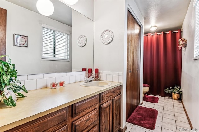 bathroom featuring tile patterned floors, vanity, toilet, and decorative backsplash