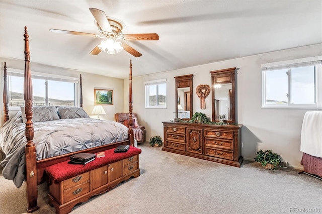 carpeted bedroom featuring multiple windows and ceiling fan