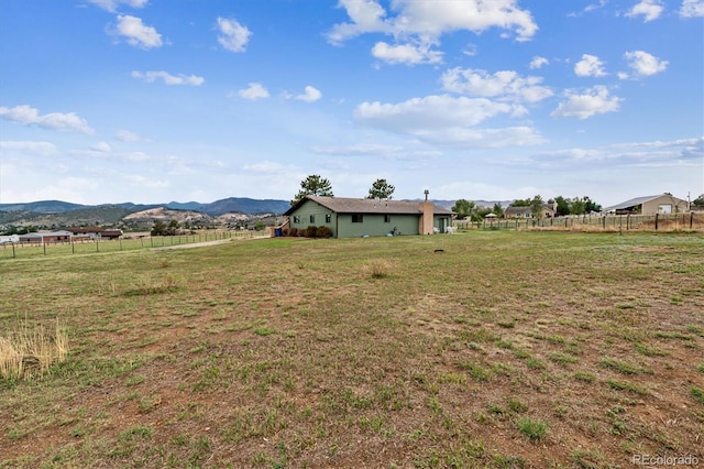 view of yard with a mountain view and a rural view