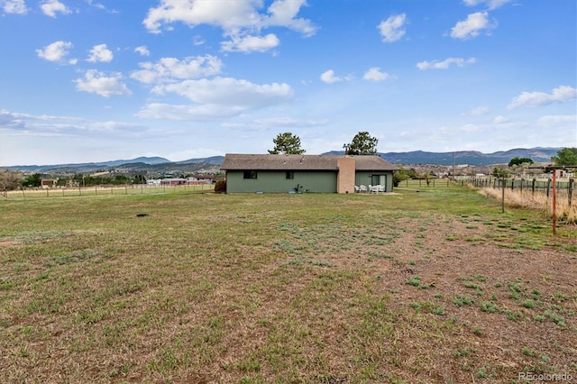 view of yard with a mountain view and a rural view