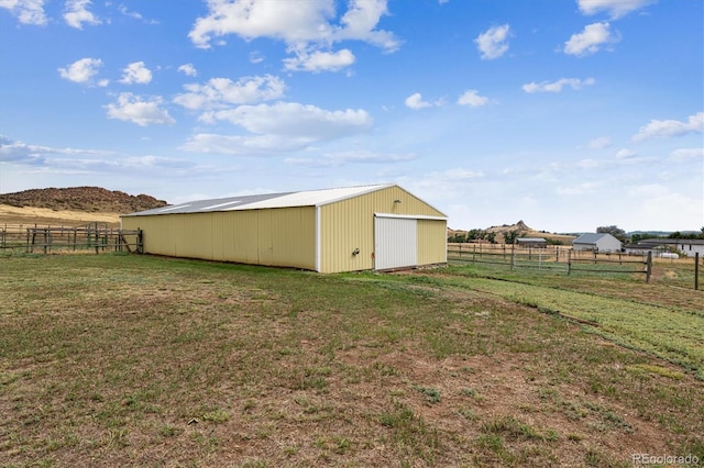 view of yard with an outbuilding and a rural view