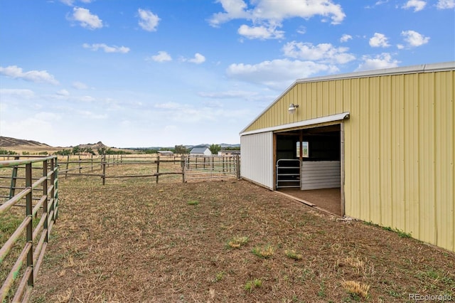 view of yard with an outbuilding and a rural view