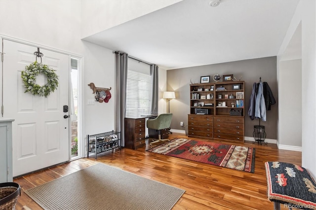 foyer with wood finished floors and baseboards