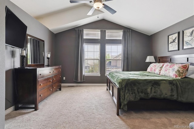 bedroom with vaulted ceiling, light colored carpet, baseboards, and ceiling fan