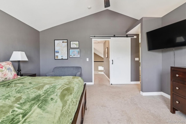 bedroom featuring light colored carpet, a barn door, baseboards, and high vaulted ceiling