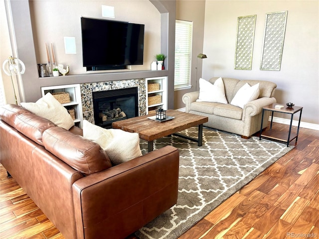 16662 W 61st Pl, Arvada, CO 80403 - living room featuring wood finished floors, baseboards, and a high end fireplace