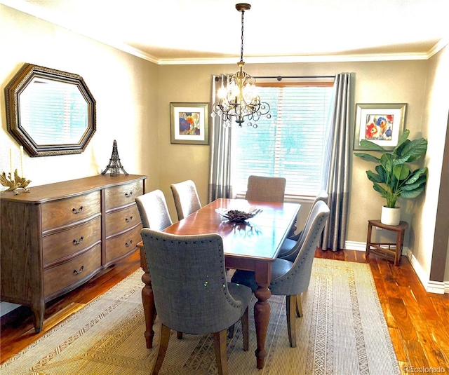 16662 W 61st Pl, Arvada, CO 80403 - dining room with a chandelier, wood finished floors, ornamental molding, and baseboards