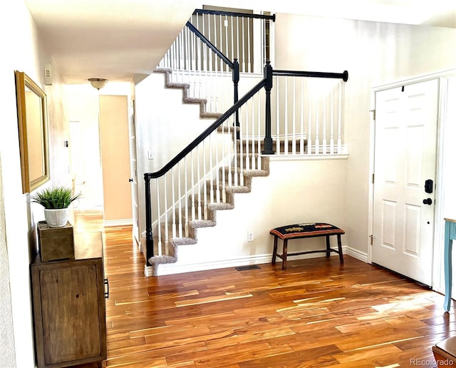 16662 W 61st Pl, Arvada, CO 80403 - foyer entrance with wood finished floors, stairs, and baseboards