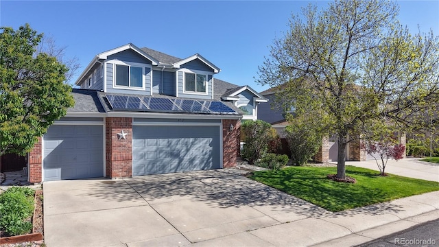view of front facade with an attached garage, concrete driveway, and brick siding