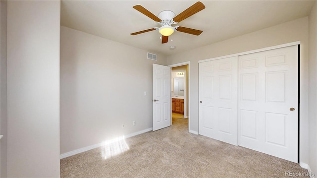 unfurnished bedroom featuring light colored carpet, a ceiling fan, baseboards, visible vents, and a closet