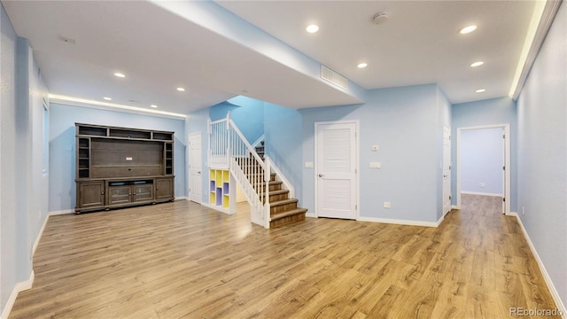 interior space featuring visible vents, baseboards, stairway, recessed lighting, and light wood finished floors