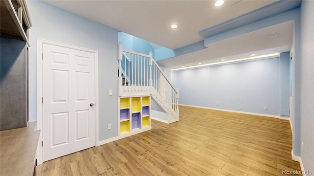 basement with stairway, baseboards, recessed lighting, and wood finished floors
