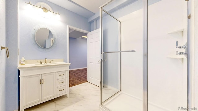 bathroom with vanity, a stall shower, and marble finish floor