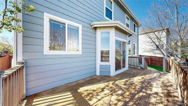 wooden terrace featuring fence