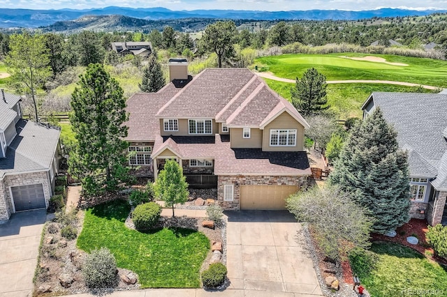 view from above of property featuring mountains and a golf course
