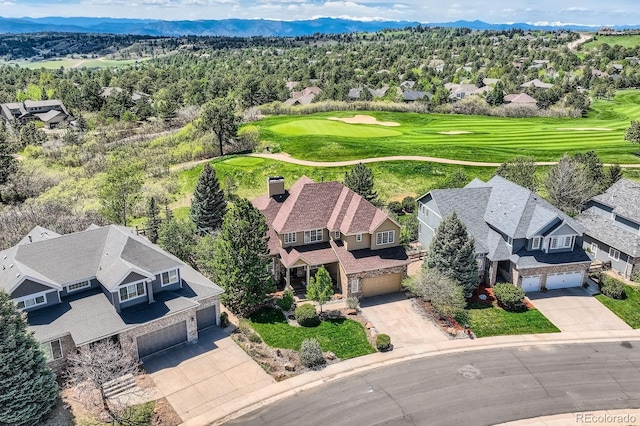 aerial perspective of suburban area featuring a golf course and mountains