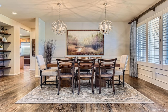 dining room with a chandelier, wood finished floors, and recessed lighting