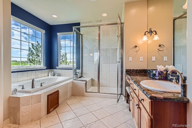 bathroom featuring vanity, a bath, a shower stall, and tile patterned floors