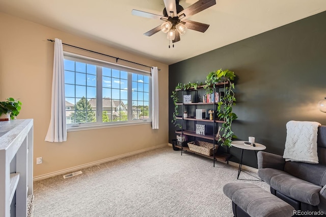 sitting room with ceiling fan, carpet flooring, and baseboards