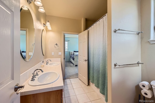 bathroom featuring tile patterned flooring, double vanity, and a shower with curtain